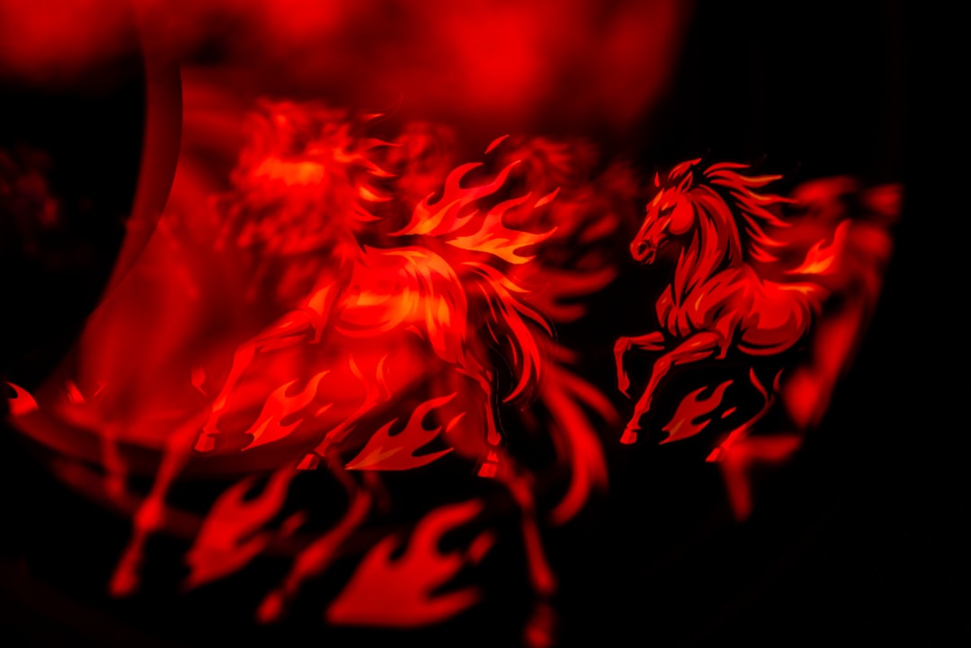 Two fiery horses running in the dark